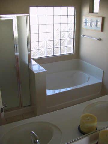 3606 West Vineyard Road Phoenix, AZ 85041 - Photo 5 of 7 a bathroom with a bathtub and shower