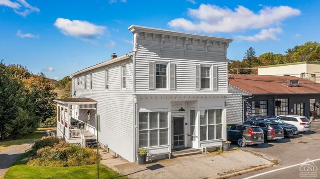 a car parked in front of a white building