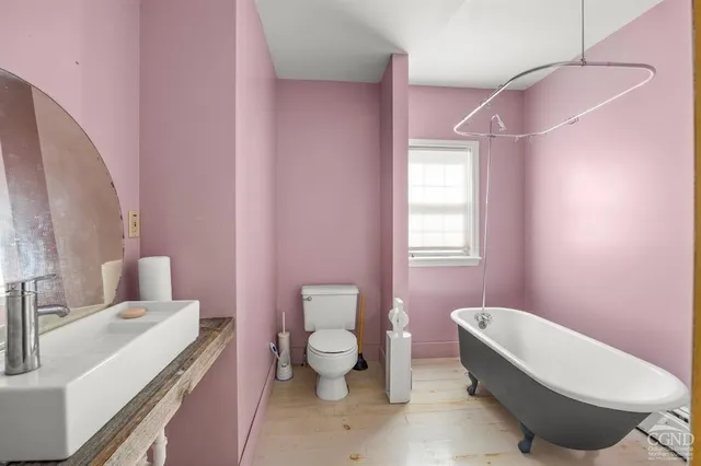 a bathroom with a sink a toilet and a mirror