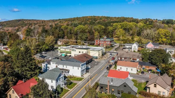 an aerial view of a residential houses with outdoor space
