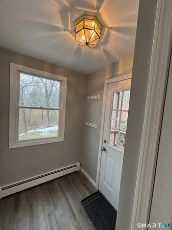 a large kitchen with stainless steel appliances granite countertop a large counter top a sink and a wooden floor