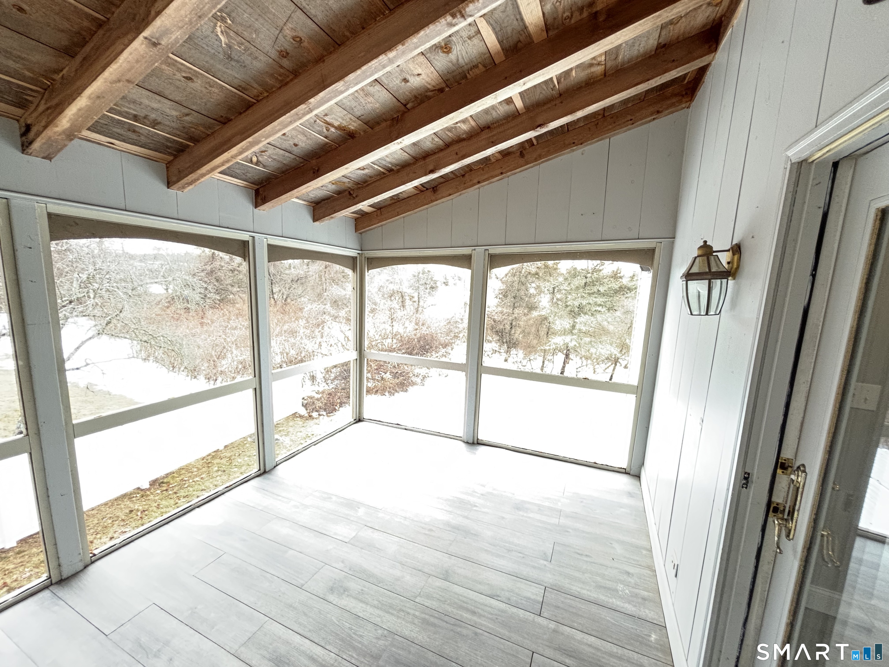 72 Ingham Hill Road Old Saybrook, CT 06475 - Photo 23 of 25 a view of an empty room with wooden floor and a large window