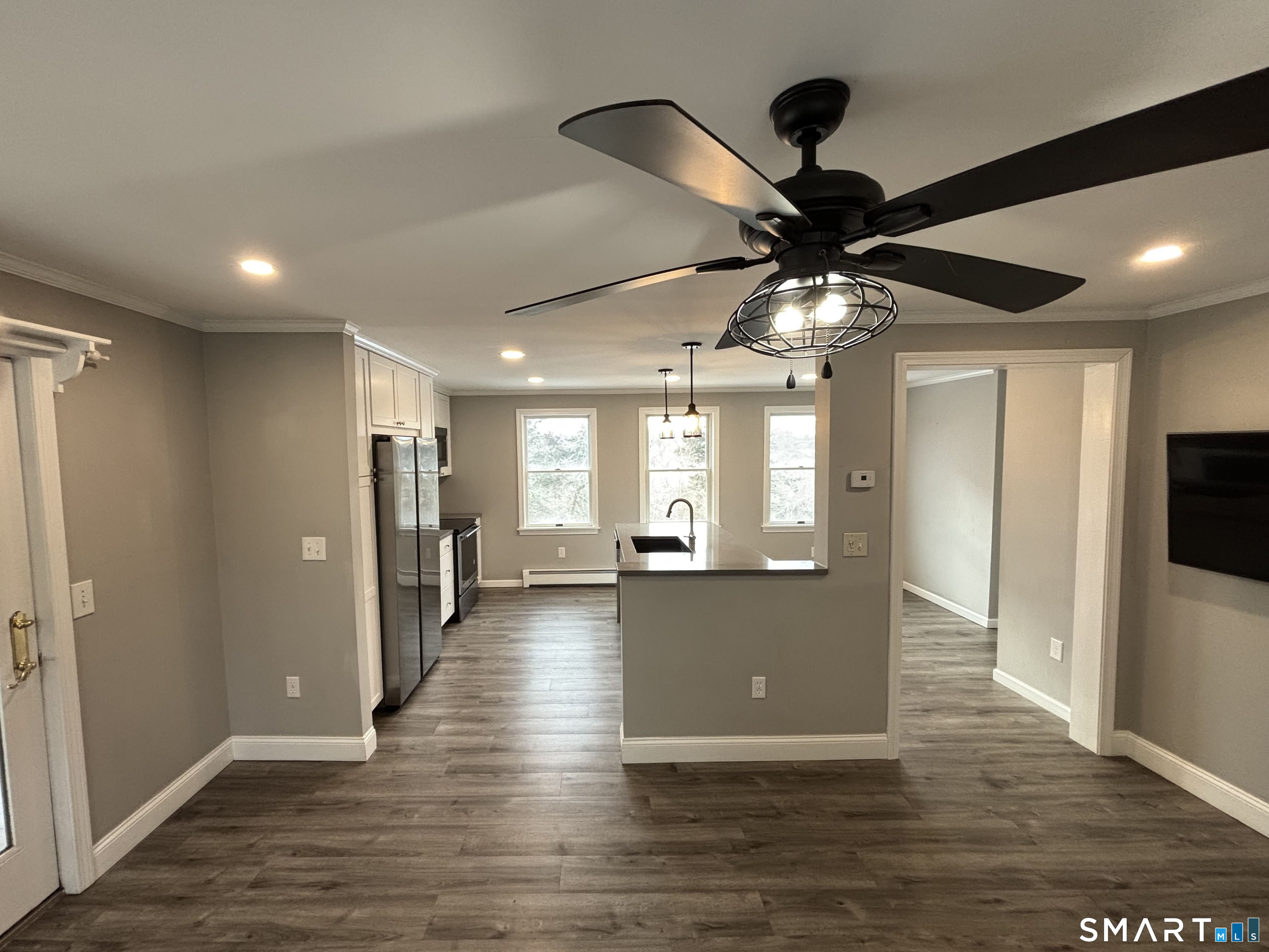 72 Ingham Hill Road Old Saybrook, CT 06475 - Photo 3 of 25 a view of an empty room and kitchen view with wooden floor