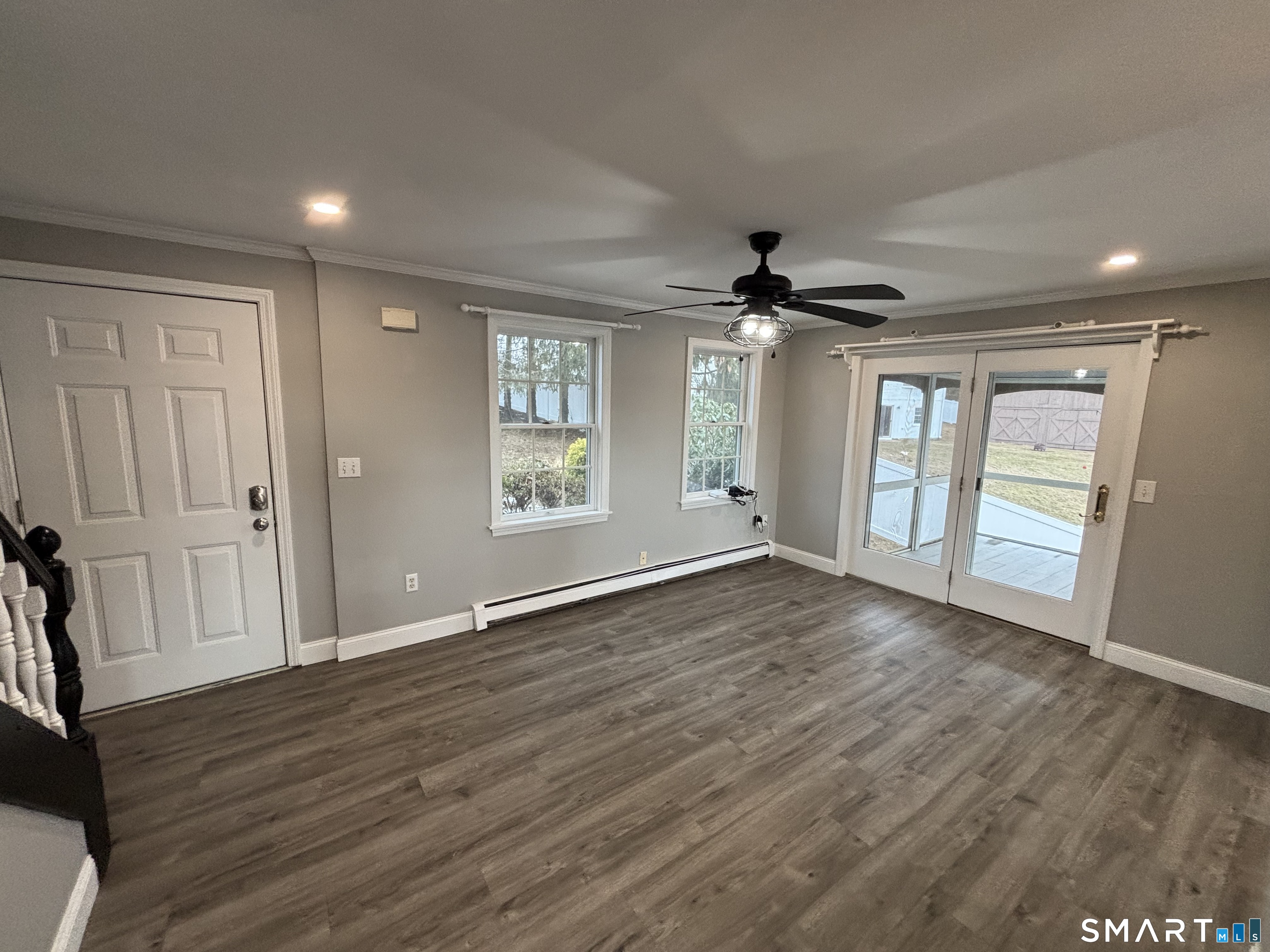 72 Ingham Hill Road Old Saybrook, CT 06475 - Photo 5 of 25 a view of an empty room with a window and wooden floor