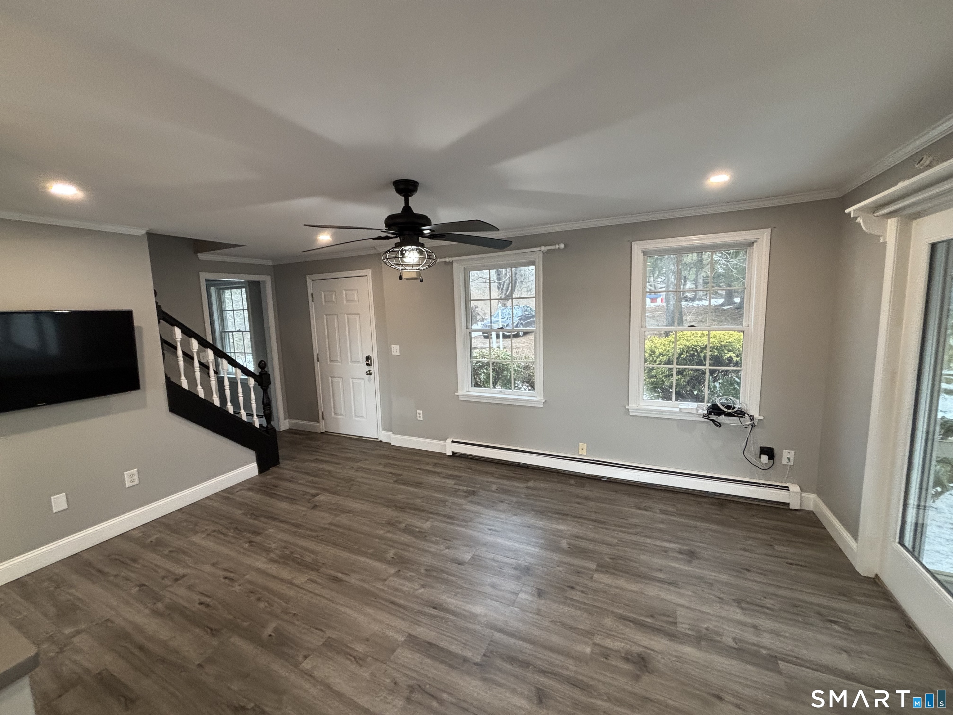 72 Ingham Hill Road Old Saybrook, CT 06475 - Photo 6 of 25 a view of an empty room with a window and wooden floor