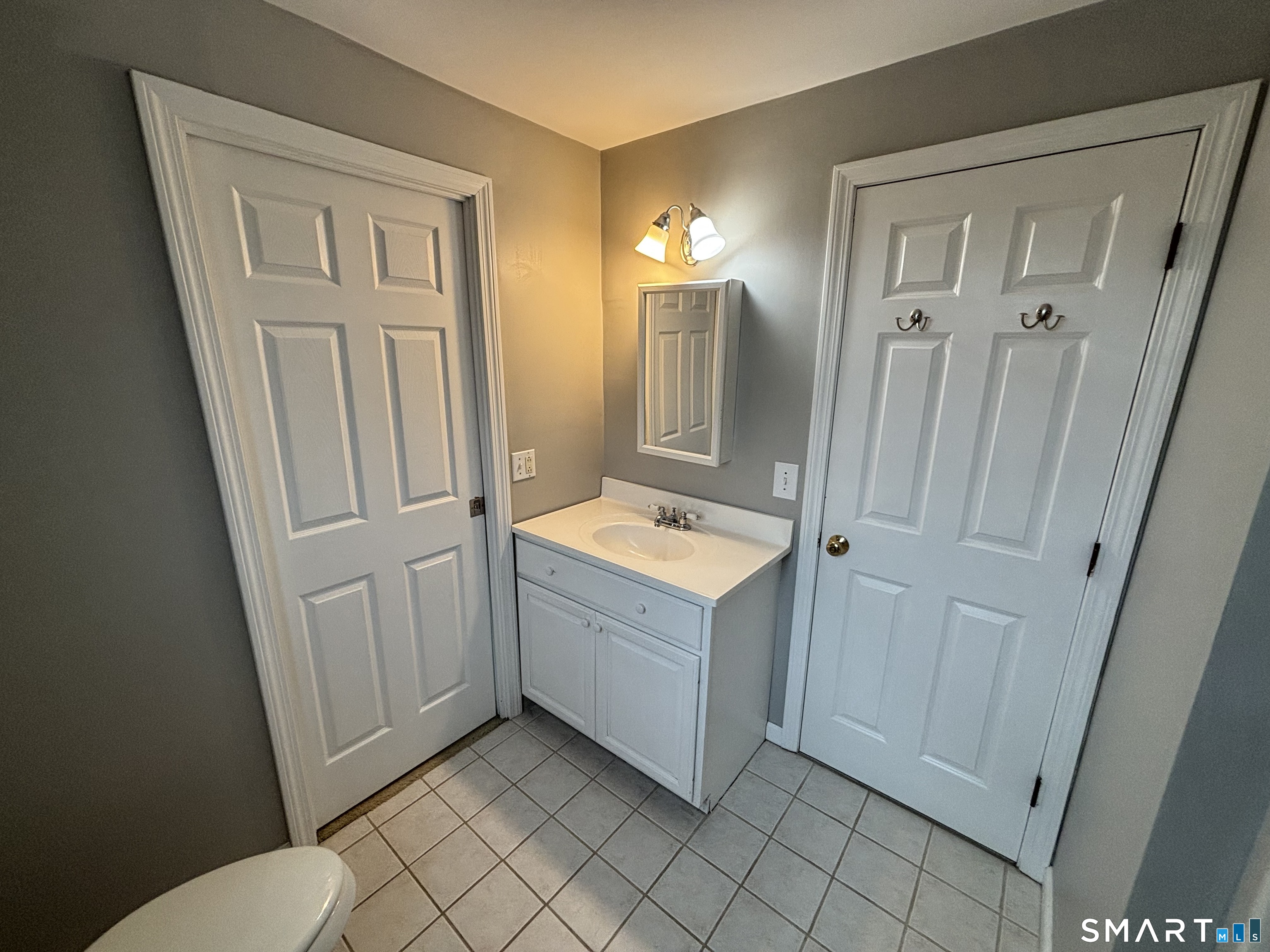 72 Ingham Hill Road Old Saybrook, CT 06475 - Photo 7 of 25 a bathroom with a sink a toilet and a mirror
