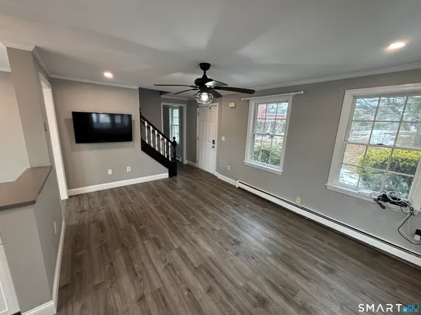 wooden floor in an empty room with a window