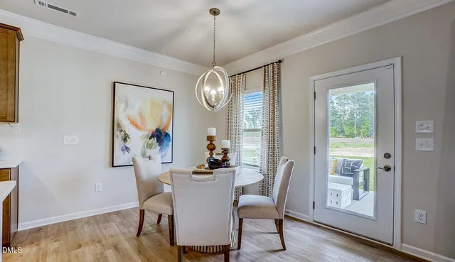 a dining room with furniture a mirror and wooden floor