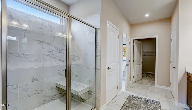 a bathroom with a glass shower door