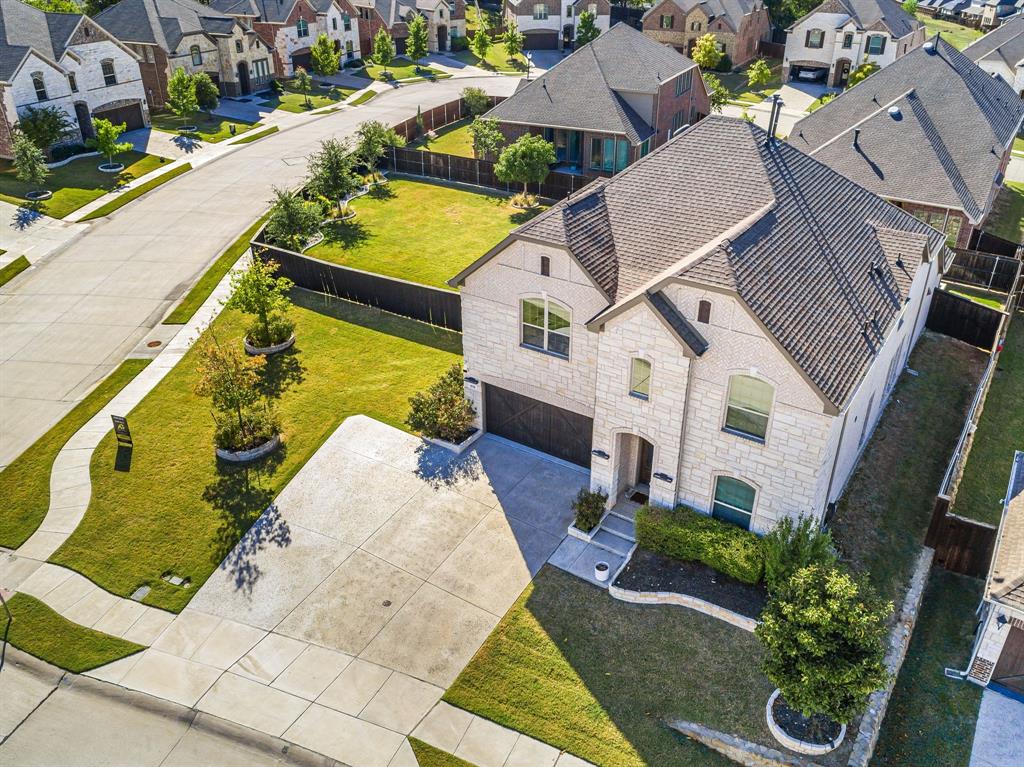 an aerial view of a house with a garden and pool