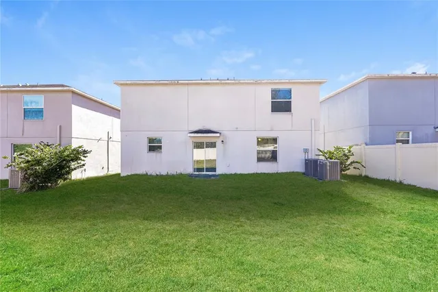 a view of a backyard with plants and a grill