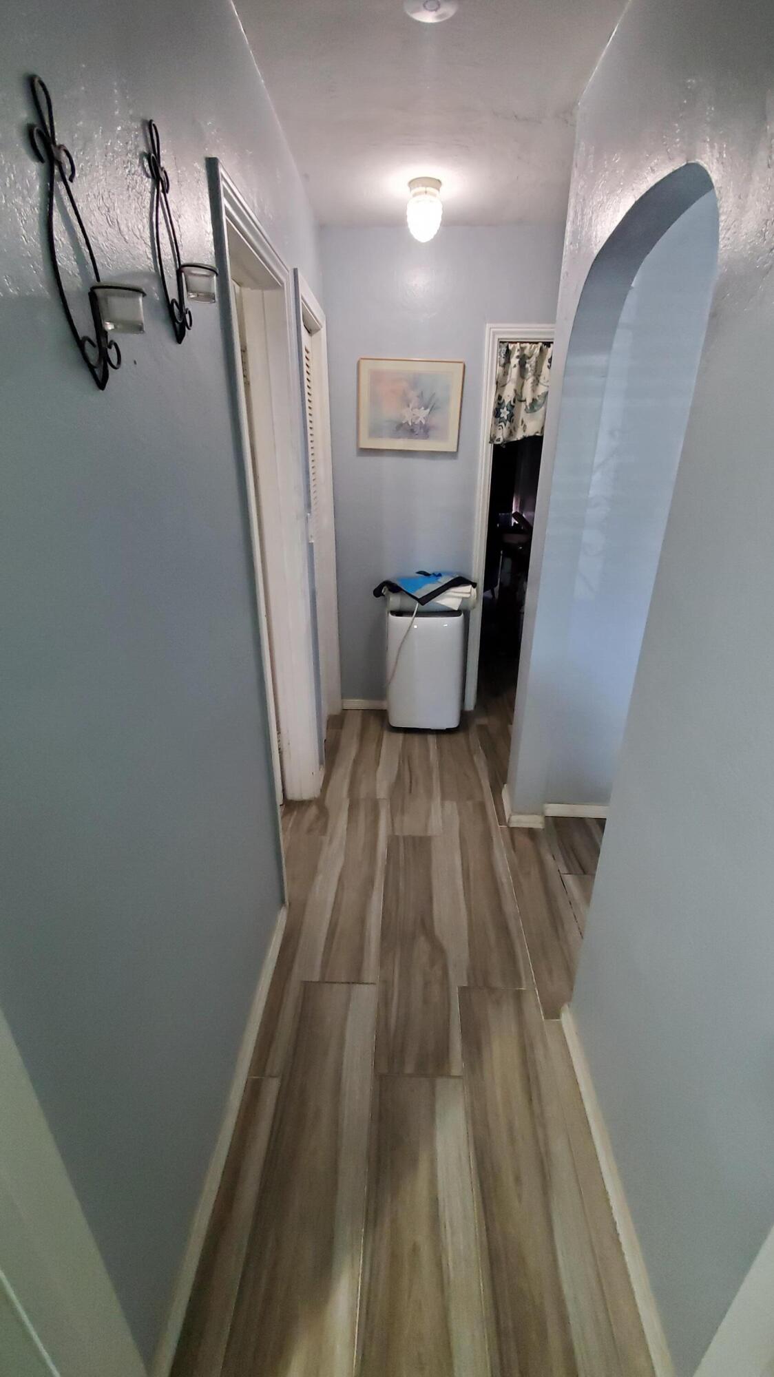 831 West George Street Banning, CA 92220 - Photo 12 of 39 a view of a hallway with wooden floor