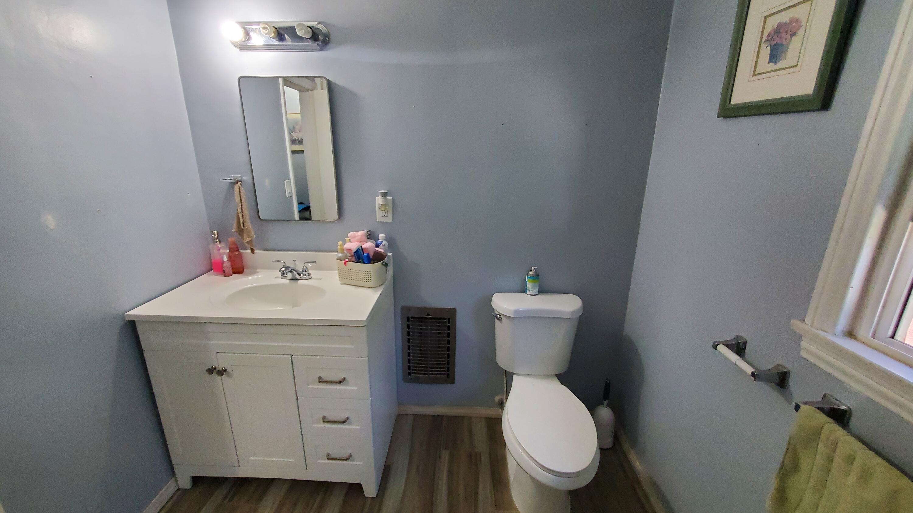 831 West George Street Banning, CA 92220 - Photo 15 of 39 a bathroom with a toilet sink and mirror