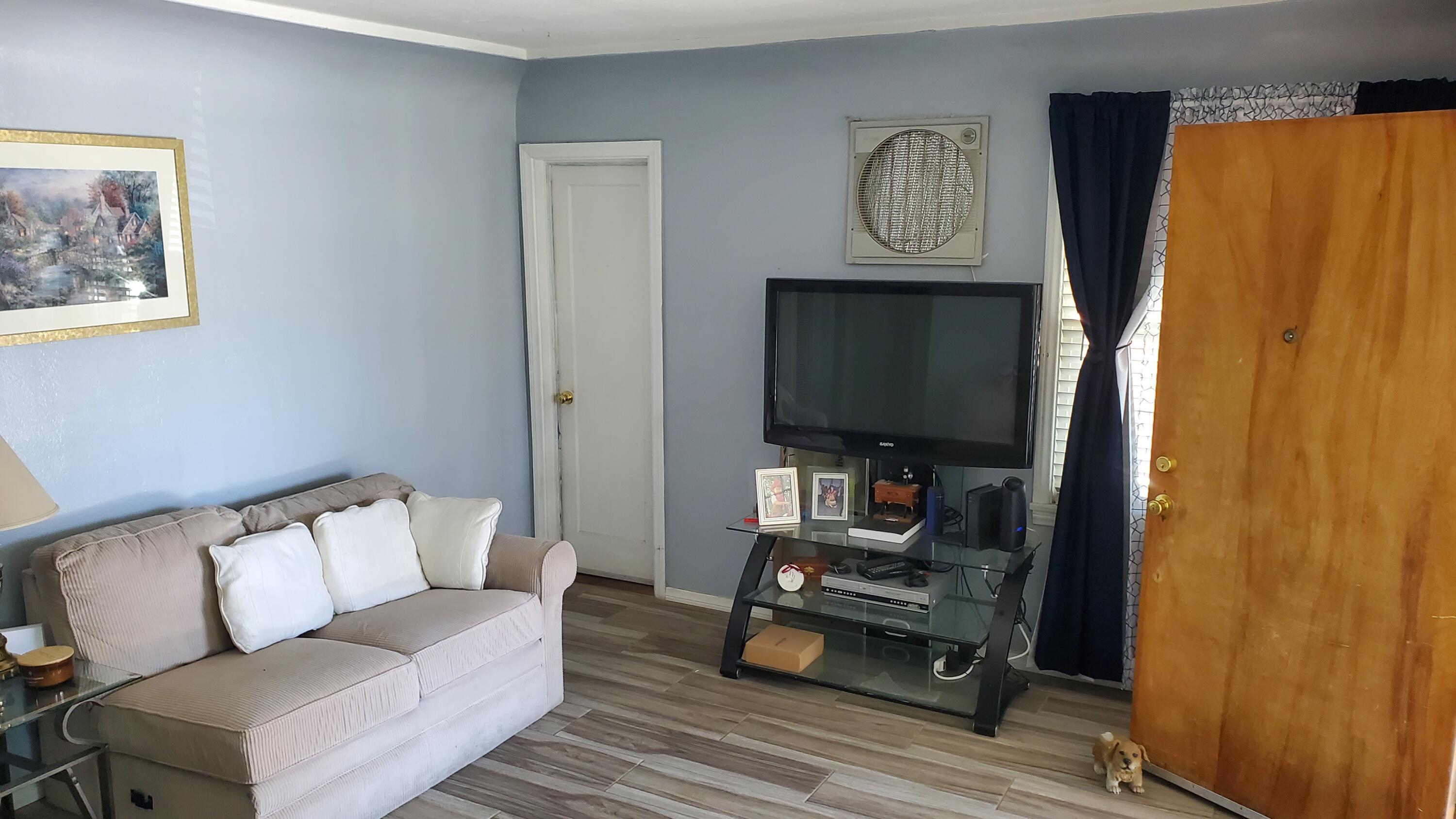831 West George Street Banning, CA 92220 - Photo 22 of 39 a living room with furniture and a flat screen tv