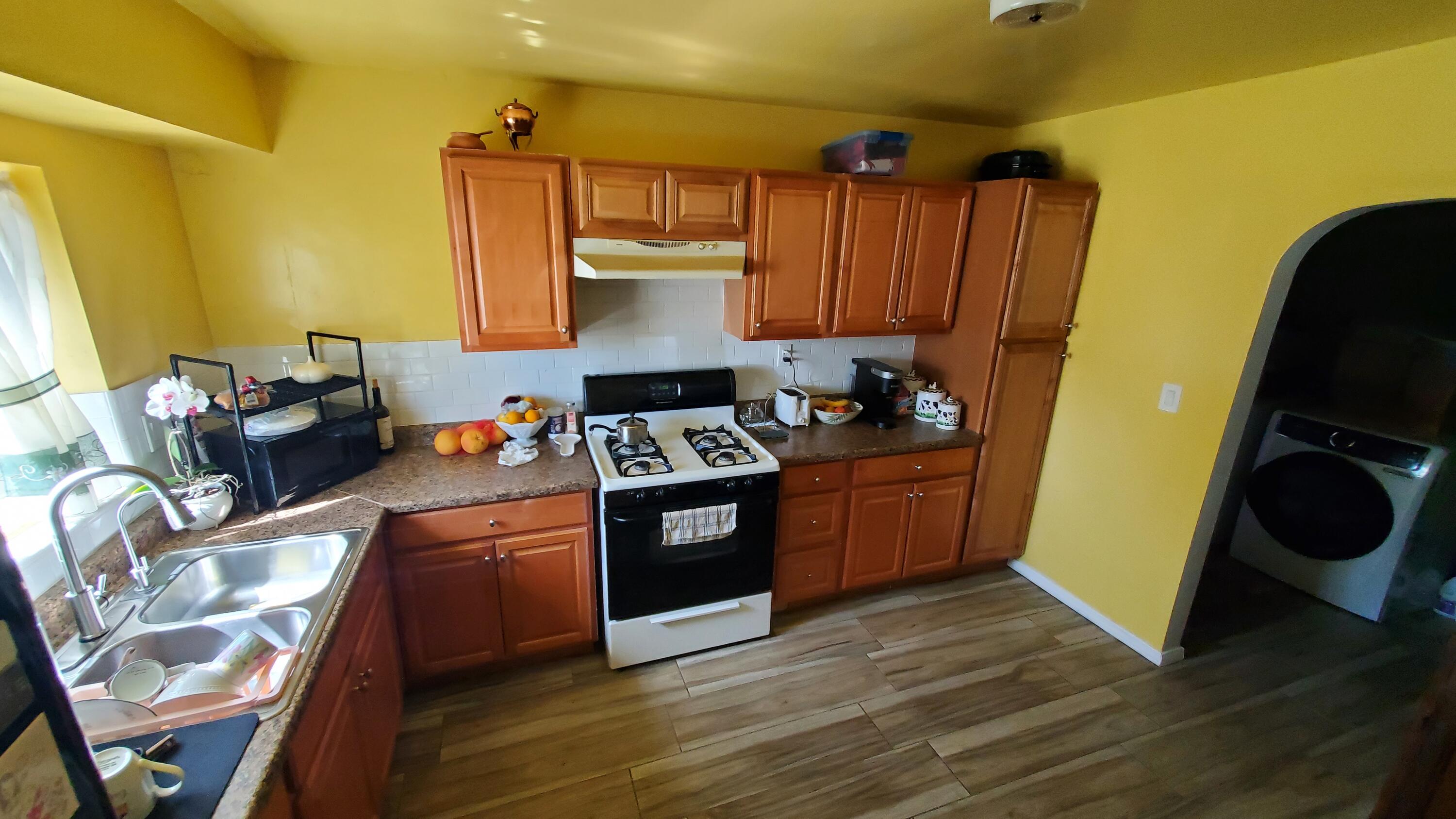 831 West George Street Banning, CA 92220 - Photo 9 of 39 a kitchen with stainless steel appliances granite countertop a sink stove and wooden floor