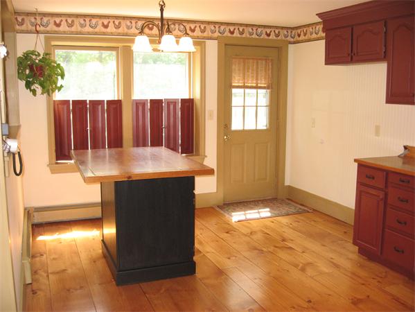 333 New Boston Road Sturbridge, MA 01566 - Photo 7 of 24 a kitchen with kitchen island a counter top space and a window