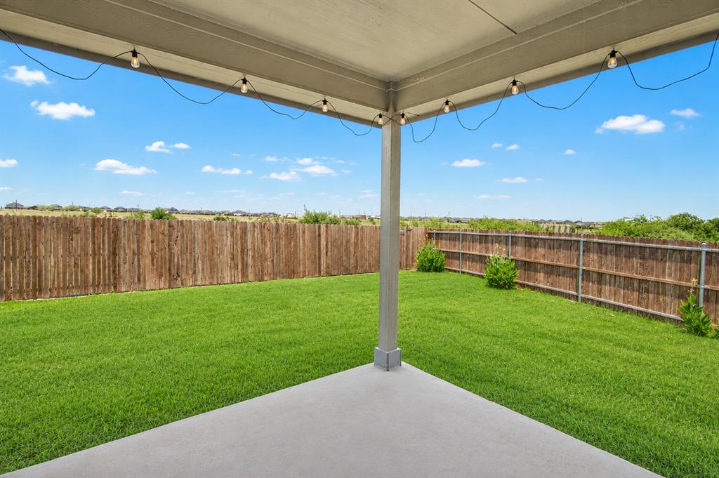 1804 Mensa Drive Haslet, TX 76052 - Photo 24 of 30 Covered concrete patio overlooking a fenced backyard with a manicured lawn
