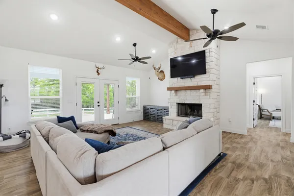 a living room with furniture a flat screen tv and a fireplace