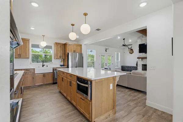 a kitchen with cabinets and wooden floor