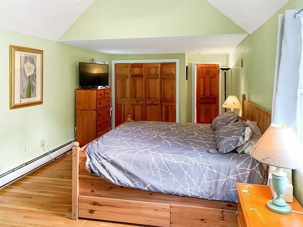 139 Simonds Road Lexington, MA 02420 - Photo 14 of 28 a bedroom with a bed and a flat tv screen on dresser
