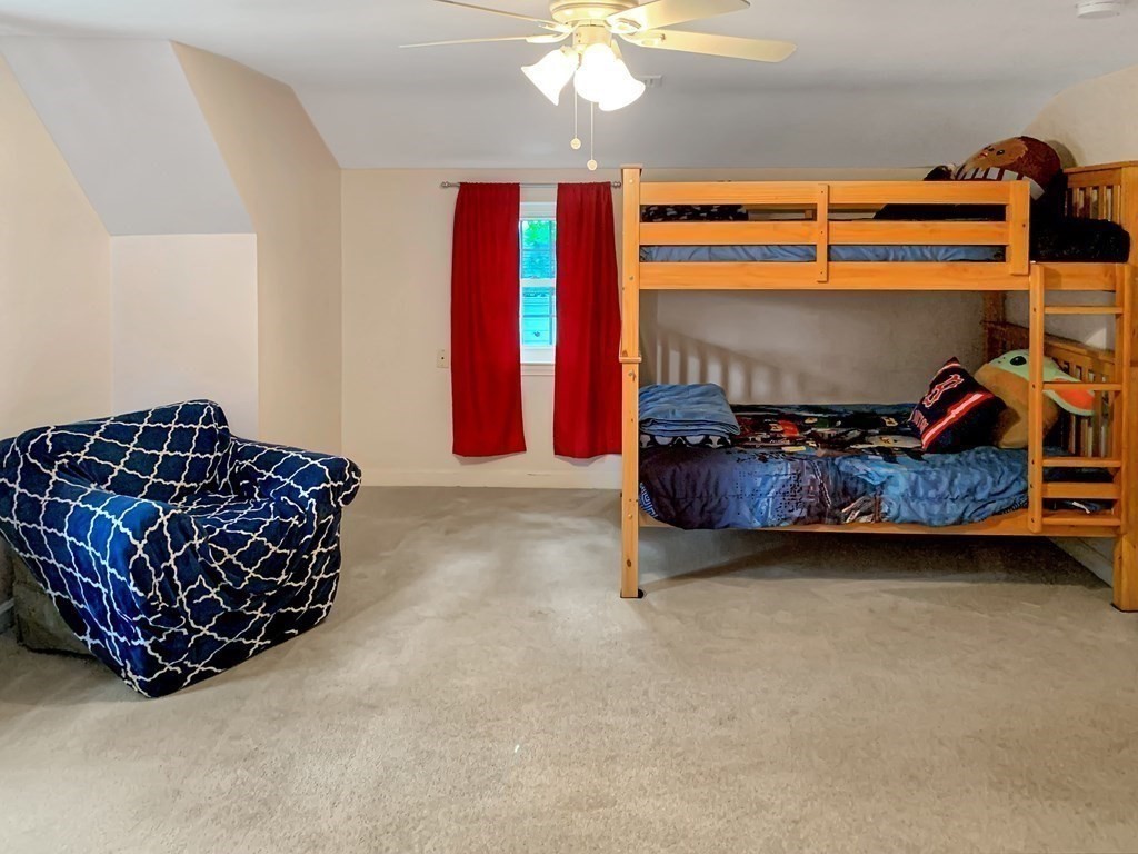 139 Simonds Road Lexington, MA 02420 - Photo 16 of 28 a bedroom with a bed and a chandelier