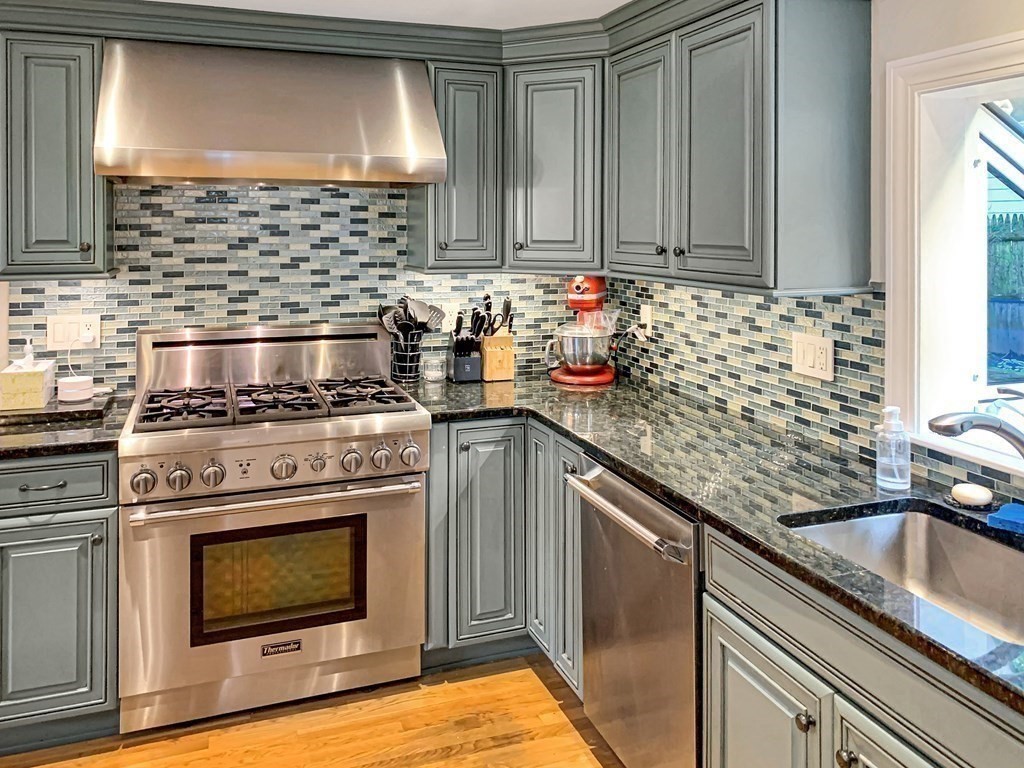 139 Simonds Road Lexington, MA 02420 - Photo 8 of 28 a kitchen with granite countertop a stove sink and cabinets