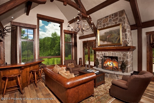 10 Popcorn Lane Aspen, CO 81611 - Photo 2 of 5 a living room with furniture a fireplace and a large window