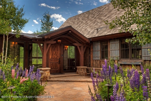 10 Popcorn Lane Aspen, CO 81611 - Photo 4 of 5 a view of a porch with chairs and potted plants