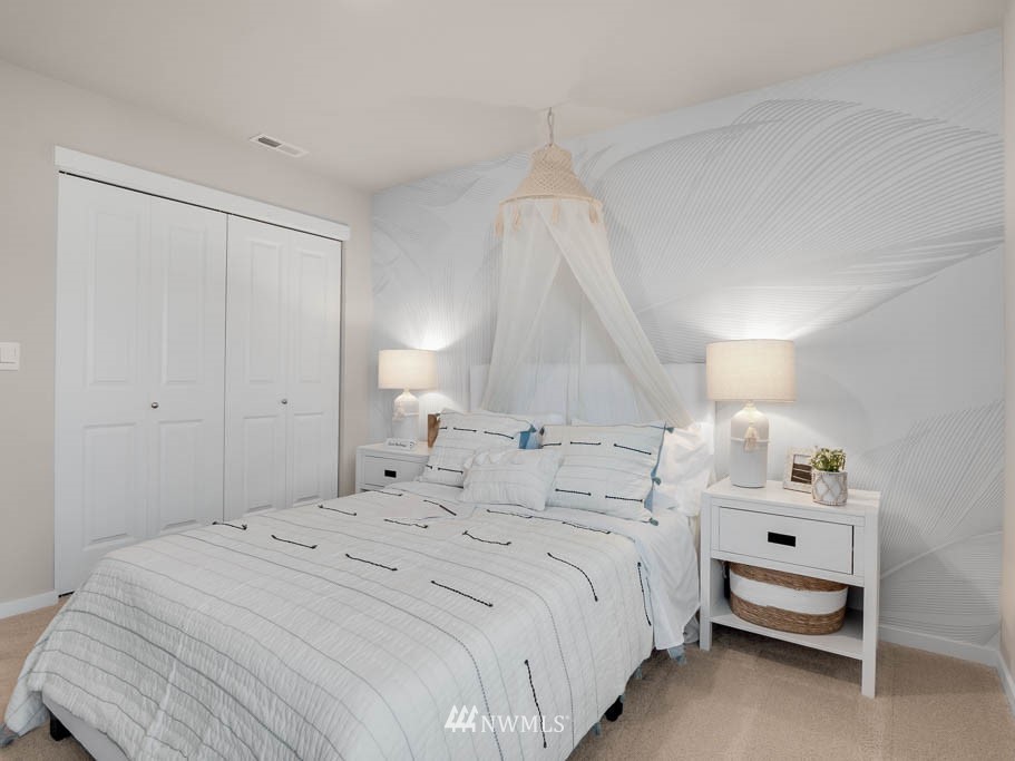 3 181st Street Southeast, Unit 13 Bothell, WA 98012 - Photo 25 of 40 a bedroom with a bed and a chandelier