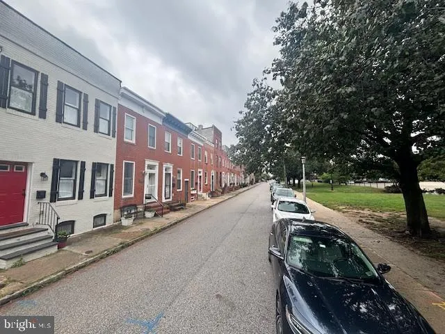 a view of a street with couches and a fire pit