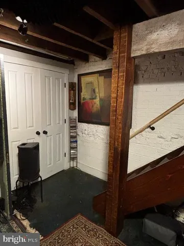 a bedroom with a bed and a flat tv screen on a dresser