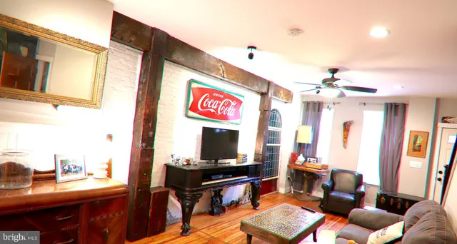 a living room with furniture flat screen tv and a fireplace