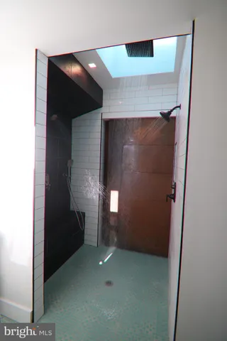 a white toilet sitting next to a white wall