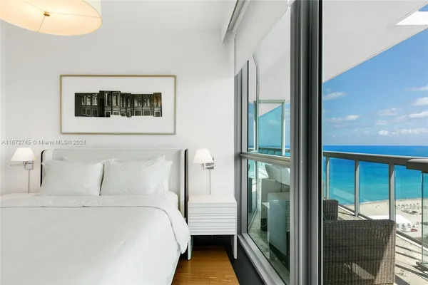 a bedroom with a large bed and a large window