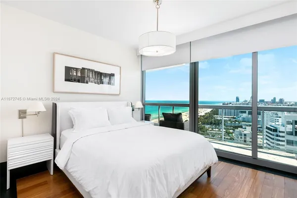 a bathroom with a granite countertop sink a mirror and shower