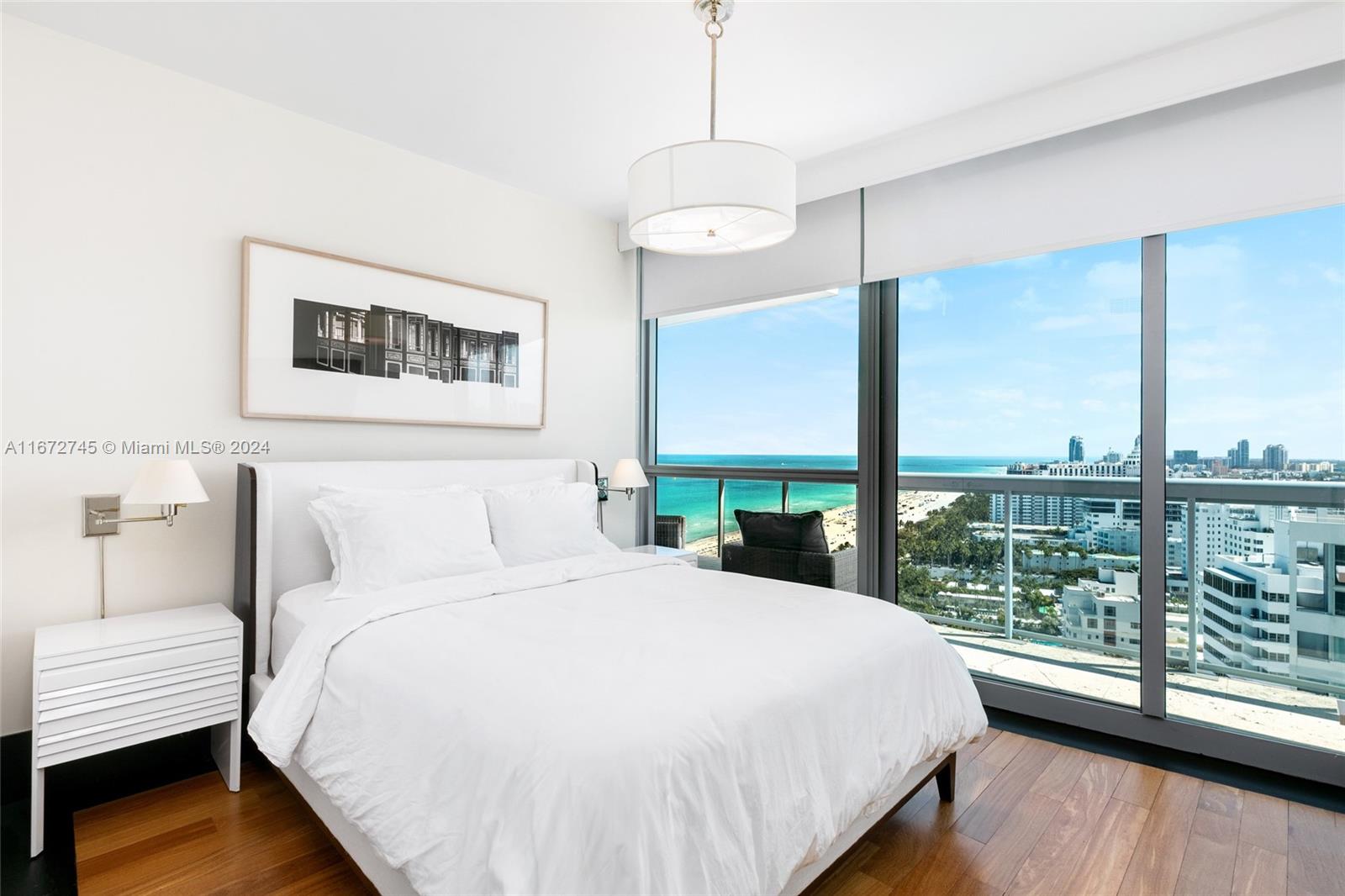 101 20th Street, Unit 2706 Miami Beach, FL 33139 - Photo 17 of 22 a bedroom with a large bed and a large window