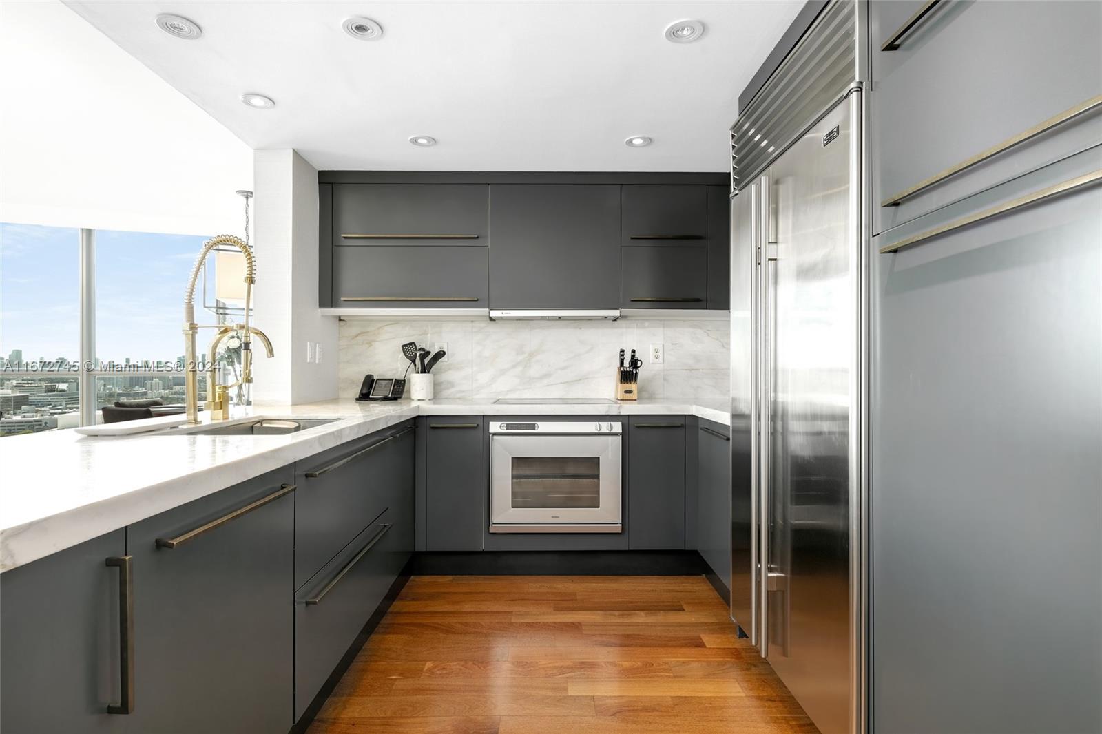 101 20th Street, Unit 2706 Miami Beach, FL 33139 - Photo 3 of 22 a kitchen with stainless steel appliances granite countertop a refrigerator and a sink