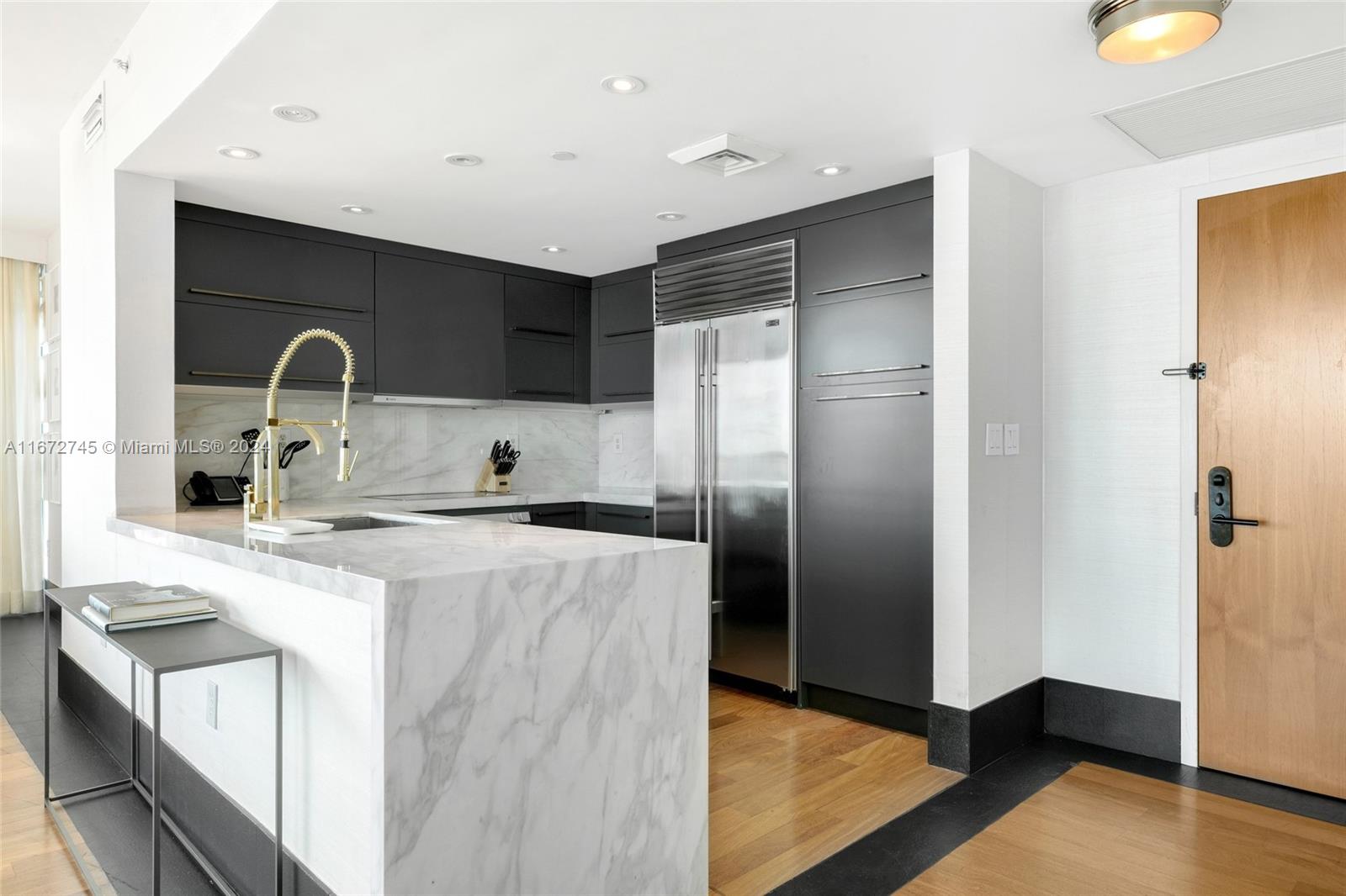 101 20th Street, Unit 2706 Miami Beach, FL 33139 - Photo 5 of 22 a kitchen with stainless steel appliances granite countertop a sink a stove and a refrigerator