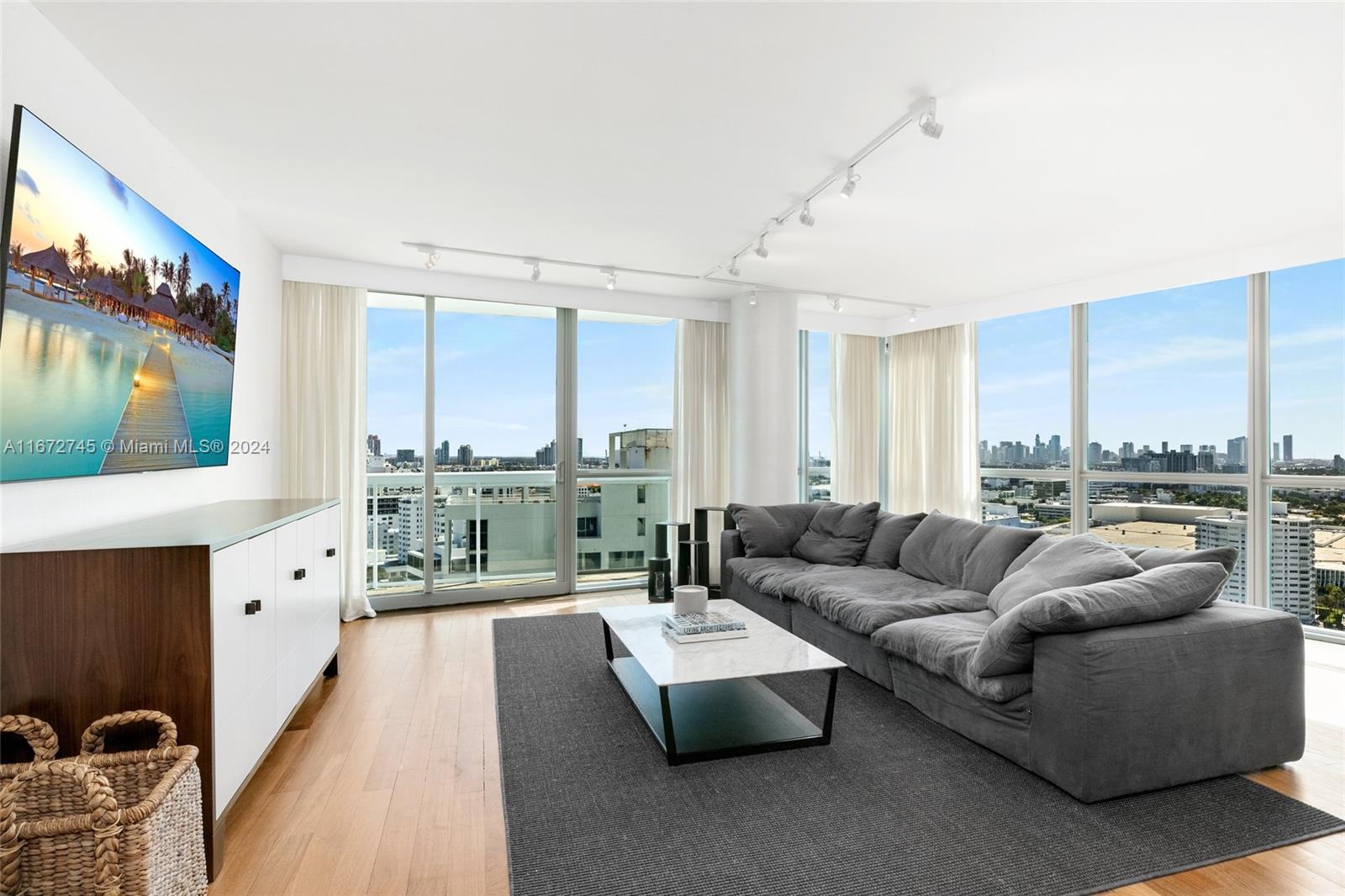 101 20th Street, Unit 2706 Miami Beach, FL 33139 - Photo 7 of 22 a living room with furniture and a floor to ceiling window