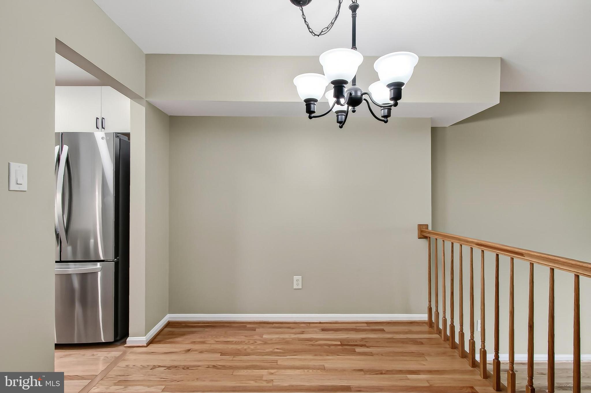 5833 Royal Ridge Drive, Unit 943 Springfield, VA 22152 - Photo 12 of 45 a view of a dining room with wooden floor