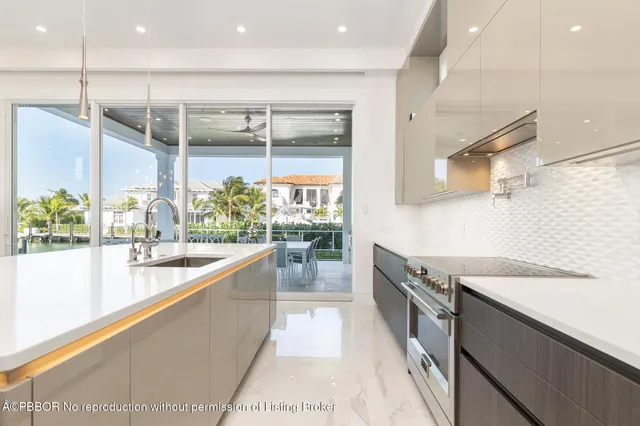 a large white kitchen with a large window