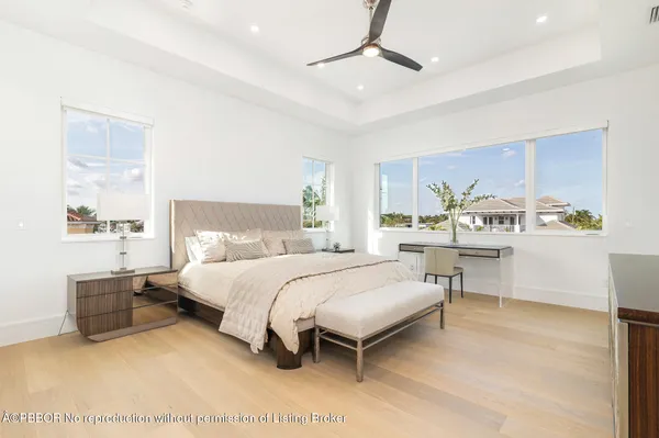 a spacious bedroom with a bed and a table in it