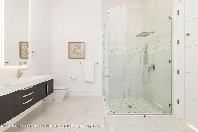a bathroom with a shower sink and mirror