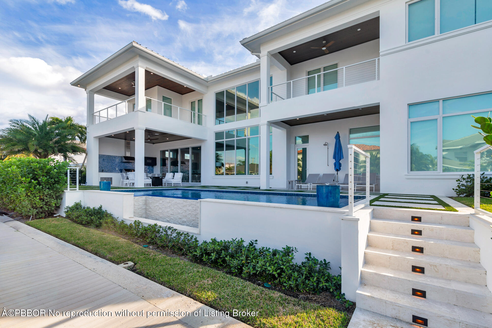 1180 Bimini Lane Riviera Beach, FL 33404 - Photo 2 of 35 a front view of a house with swimming pool and glass windows