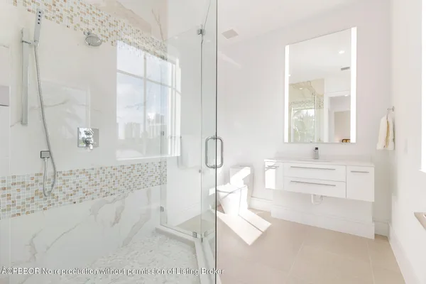 a spacious bathroom with a double vanity sink a mirror and a shower