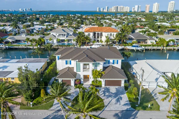 an aerial view of ocean and residential building with outdoor space