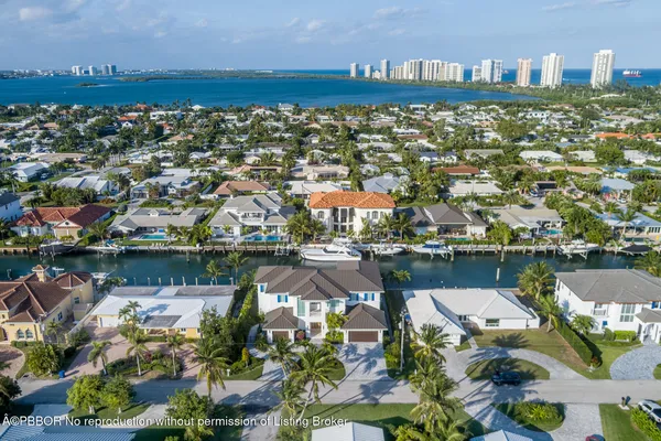 an aerial view of a house with a lake