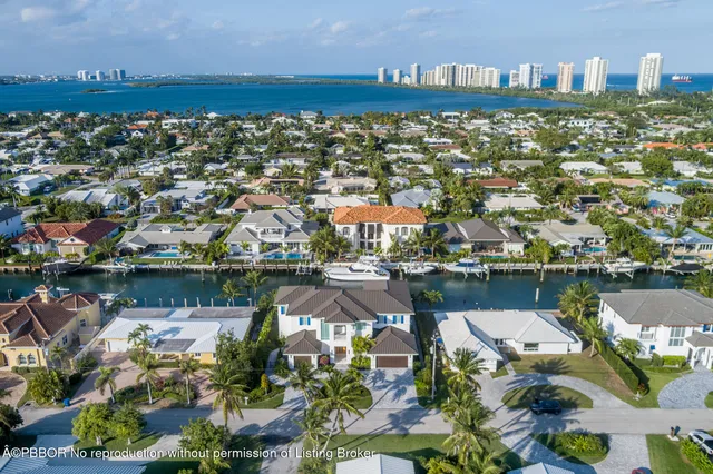 an aerial view of a house with a lake