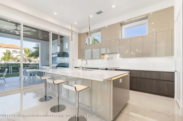 a kitchen with a sink a stove a refrigerator and cabinets