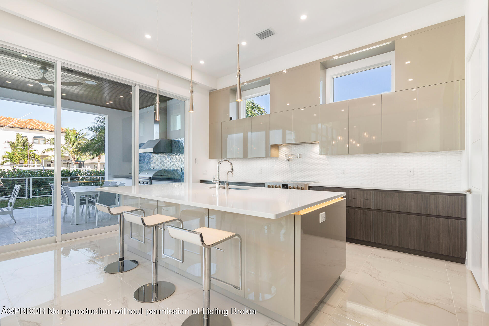 1180 Bimini Lane Riviera Beach, FL 33404 - Photo 10 of 35 a kitchen with a sink a stove a refrigerator and cabinets